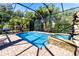 Screened pool and spa with brick patio and lush landscaping at 17221 Elder Ave, Port Charlotte, FL 33954
