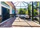 Relaxing screened patio with brick pavers and comfortable seating area at 17221 Elder Ave, Port Charlotte, FL 33954