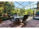 Bright screened patio with table and chairs, perfect for dining al fresco at 17221 Elder Ave, Port Charlotte, FL 33954