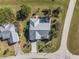 Aerial view of a home with a pool, driveway, and neighboring houses at 17466 Fuego Ln, Punta Gorda, FL 33955