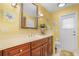 Bathroom with light marble vanity top and wooden cabinets at 17466 Fuego Ln, Punta Gorda, FL 33955