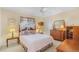 Cozy bedroom with wooden furniture, a comfortable bed, and soft carpeting at 17466 Fuego Ln, Punta Gorda, FL 33955