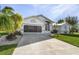 Charming curb appeal with lush landscaping and palm trees at 17466 Fuego Ln, Punta Gorda, FL 33955