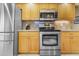 Kitchen features stainless steel appliances, wood cabinetry, and granite countertops at 17466 Fuego Ln, Punta Gorda, FL 33955