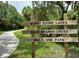 Wooden sign for Burnt Store Lakes, Bear Branch Creek, and the multi-use path at 17466 Fuego Ln, Punta Gorda, FL 33955