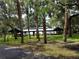 Covered picnic pavilion with metal roof surrounded by palm trees and green space at 17466 Fuego Ln, Punta Gorda, FL 33955