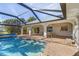 Screened-in pool area with brick pavers and views of the backyard at 17466 Fuego Ln, Punta Gorda, FL 33955