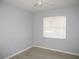Bedroom with light gray walls and laminate wood flooring at 21471 Dranson Ave, Port Charlotte, FL 33952