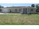 Charming single story home with a simple front yard and an attached garage on a sunny day at 21471 Dranson Ave, Port Charlotte, FL 33952