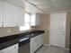Kitchen with white cabinets, granite countertops, and stainless steel appliances at 21471 Dranson Ave, Port Charlotte, FL 33952