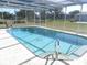 Inviting screened-in pool with tiled accents at 21471 Dranson Ave, Port Charlotte, FL 33952