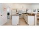 Kitchen with white appliances, white cabinets, and an adjacent laundry room at 219 White Marsh Ln, Rotonda West, FL 33947