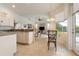 Kitchen and dining area with tile flooring, white cabinets, and a view of the Gathering room at 219 White Marsh Ln, Rotonda West, FL 33947