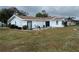 Rear view of a white single story home with patio and lake view at 2436 Nuremberg Blvd, Punta Gorda, FL 33983