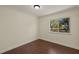 Empty bedroom with wood-look flooring and a large window at 31 Twig Ct, Port Charlotte, FL 33954