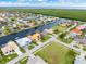 Aerial view of a waterfront community with canals, boat docks, and lush greenery surrounding the homes at 3948 La Costa Island Ct, Punta Gorda, FL 33950