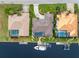 Bird's-eye view of three waterfront homes, each with a private pool at 3948 La Costa Island Ct, Punta Gorda, FL 33950