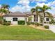 Single-Gathering home with palm trees and a large yard at 3948 La Costa Island Ct, Punta Gorda, FL 33950