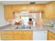 Kitchen with light wood cabinets, double sink, and dishwasher at 4048 Oakview Dr # F2-4, Punta Gorda, FL 33980