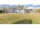 Large grassy backyard featuring a screened-in pool at 4317 Eldron Ave, North Port, FL 34286