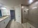 Bright bathroom featuring a double sink vanity, tile floors, and a glass-enclosed shower at 507 San Ambrosio St, Punta Gorda, FL 33983