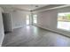 Large bedroom with tray ceiling, gray flooring, and abundant natural light from the windows at 507 San Ambrosio St, Punta Gorda, FL 33983