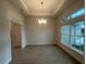 Dining room featuring a tray ceiling, tile floors, and a modern chandelier at 507 San Ambrosio St, Punta Gorda, FL 33983