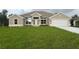Charming single-story home with a manicured lawn and neutral paint scheme, complemented by an attached two-car garage at 507 San Ambrosio St, Punta Gorda, FL 33983