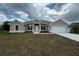 Charming single-story home featuring a manicured lawn, two-car garage, and beautifully coordinated exterior paint scheme at 507 San Ambrosio St, Punta Gorda, FL 33983