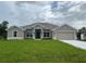 Charming single-story home with a manicured lawn and neutral paint scheme, complemented by an attached two-car garage at 507 San Ambrosio St, Punta Gorda, FL 33983