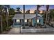 Charming light blue house with white picket fence and a well-manicured lawn at 509 W Olympia Ave, Punta Gorda, FL 33950