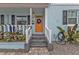 Inviting front porch with orange door and white railings at 509 W Olympia Ave, Punta Gorda, FL 33950