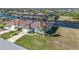 Aerial view of a waterfront home with a boat dock and lush landscaping at 9199 Key West St, Port Charlotte, FL 33981