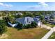 An aerial view of a house with a large lot, a backyard with a pool, and surrounded by a white fence at 1010 Sheehan Blvd, Port Charlotte, FL 33952