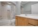 Bathroom with tiled shower, single vanity, and wood cabinetry at 1010 Sheehan Blvd, Port Charlotte, FL 33952