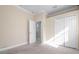 Empty bedroom with carpet, white closet doors, and a door leading to another room at 1010 Sheehan Blvd, Port Charlotte, FL 33952