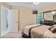 Bedroom with a queen bed, dresser, and access to bathroom at 1169 Guild St, Port Charlotte, FL 33952