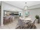 Dining area with modern pendant lighting and access to the kitchen area with breakfast bar seating at 1190 Victoria Ave Nw, Port Charlotte, FL 33948