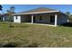 Spacious backyard with a covered patio area perfect for outdoor entertaining and relaxation at 12051 Crossgate Ave, Port Charlotte, FL 33981