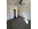 Bright bedroom with neutral walls, ceiling fan, and tile floors, offering a comfortable retreat at 12051 Crossgate Ave, Port Charlotte, FL 33981