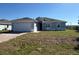 Charming home featuring a garage, well-maintained landscaping, and a welcoming curb appeal at 12051 Crossgate Ave, Port Charlotte, FL 33981