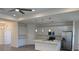 Modern kitchen features stainless steel appliances, island, and white cabinetry at 12051 Crossgate Ave, Port Charlotte, FL 33981