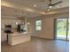 Modern kitchen features stainless steel appliances, island, and sliding glass door access at 12051 Crossgate Ave, Port Charlotte, FL 33981