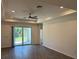 Bright living room featuring tile floors, recessed lighting, and a sliding glass door at 12051 Crossgate Ave, Port Charlotte, FL 33981