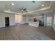 Spacious living room and kitchen combo features tile floors and modern fixtures at 12051 Crossgate Ave, Port Charlotte, FL 33981