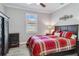 Cozy bedroom with a red plaid comforter and dark wood furniture at 12750 Oriago St, Venice, FL 34293