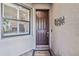 Dark brown front door with sidelights and a welcome mat at 12750 Oriago St, Venice, FL 34293
