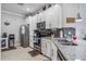 Modern kitchen with stainless steel appliances and granite countertops at 12750 Oriago St, Venice, FL 34293