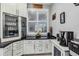 Modern kitchen with stainless steel appliances and granite countertops at 12750 Oriago St, Venice, FL 34293