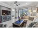 Open living area with sectional sofa, large TV, and water view at 12750 Oriago St, Venice, FL 34293